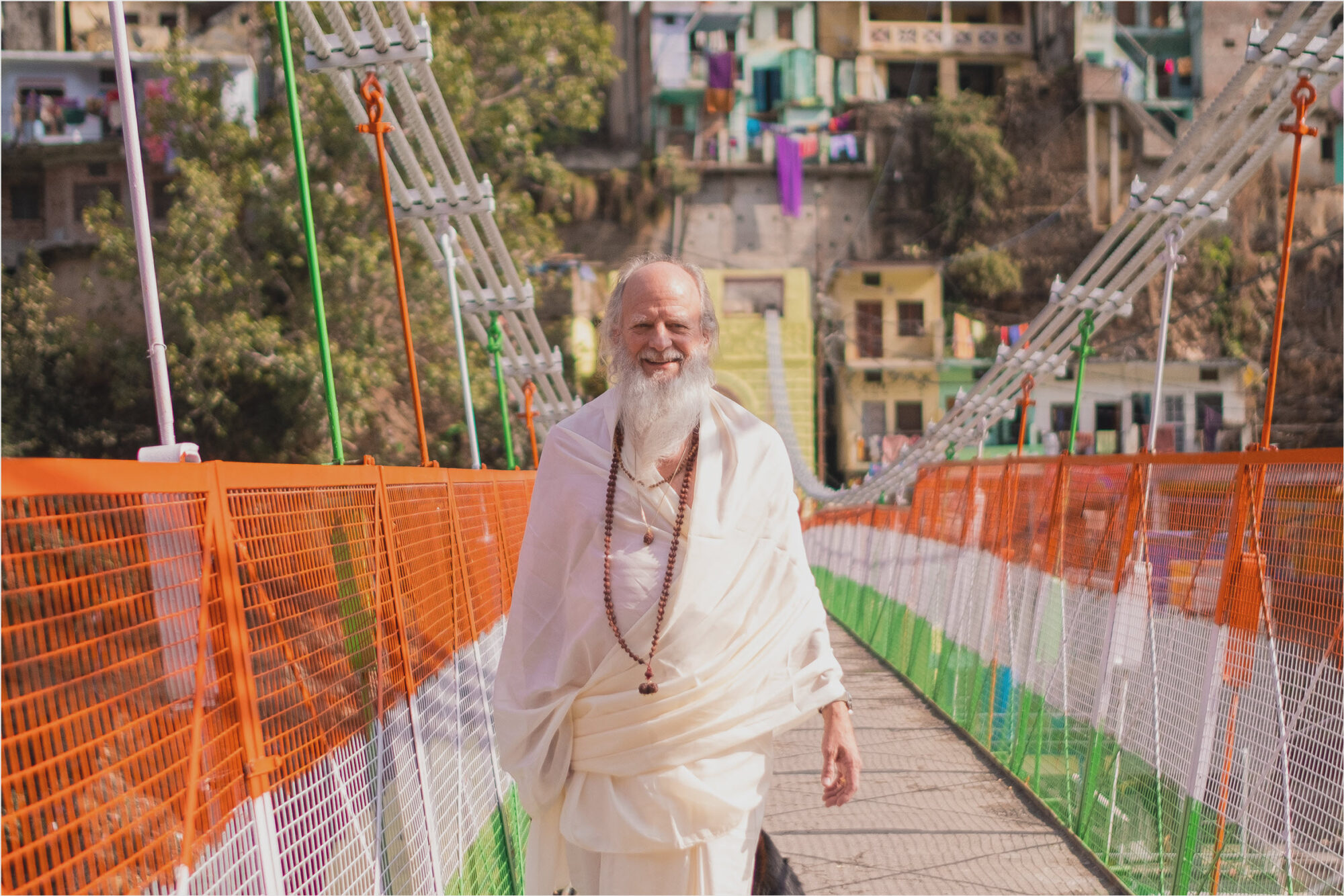 Thom Knoles walking over a bridge in India