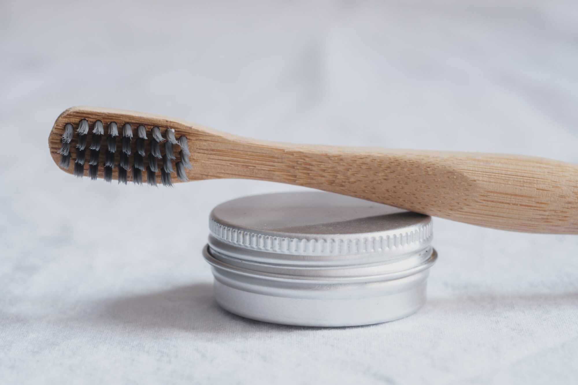 small metal tin with tooth brush
