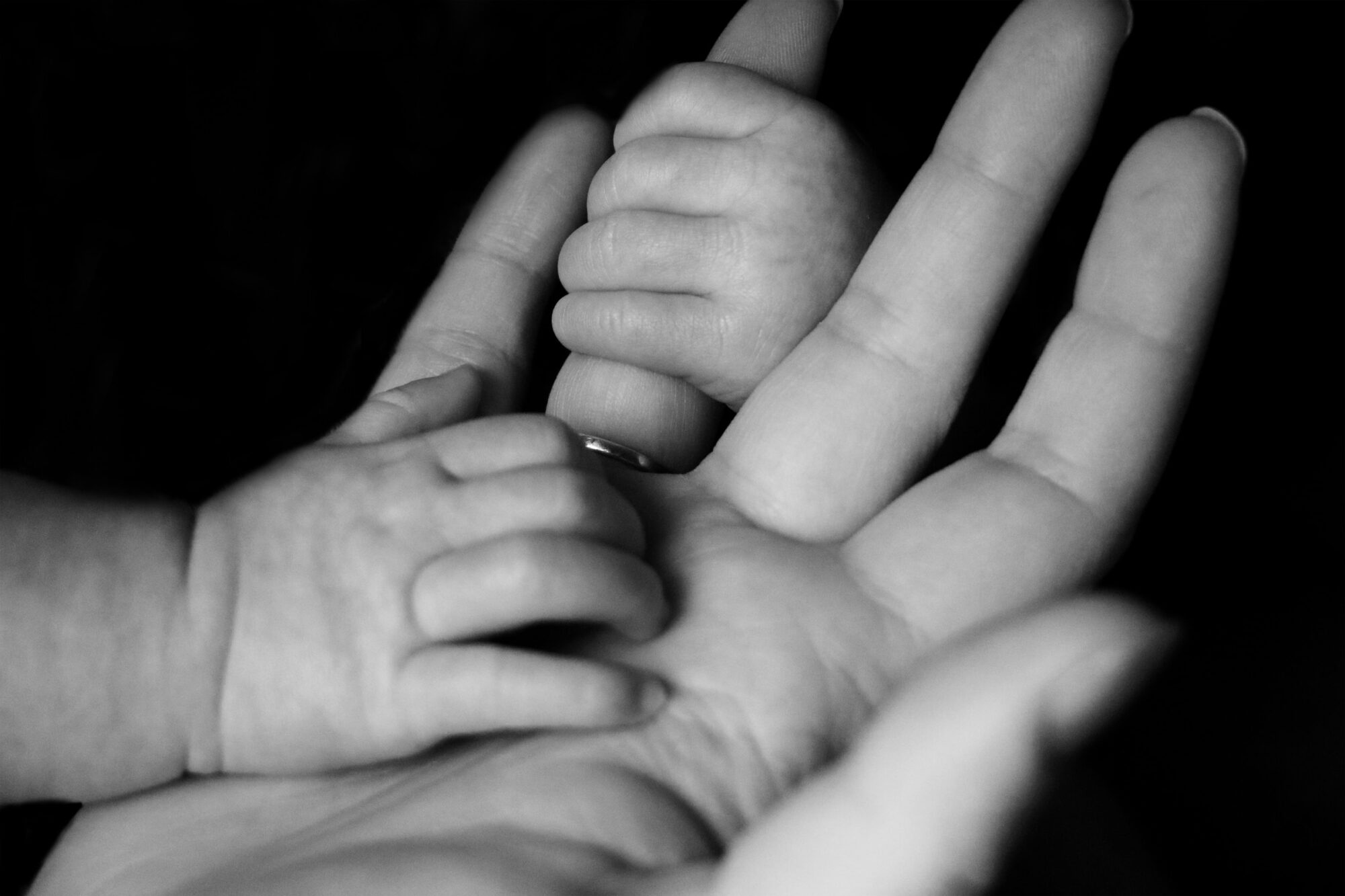 baby hand holding mother's hand