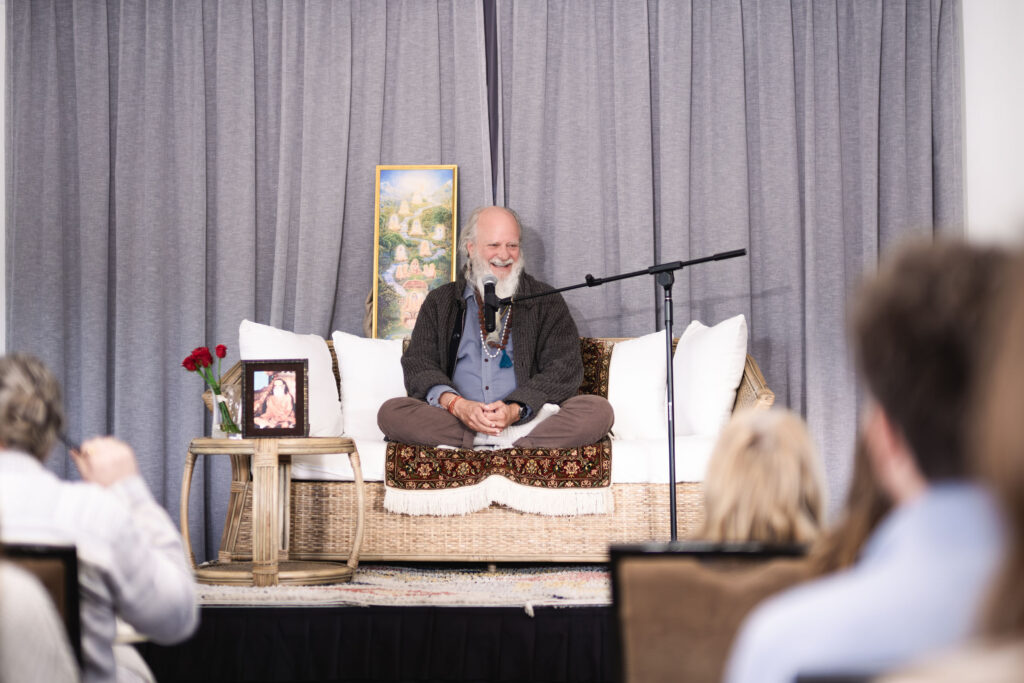 Thom Knoles sitting talking infront of people