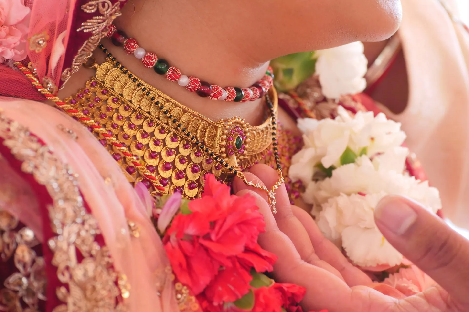 woman wearing gold pink necklace