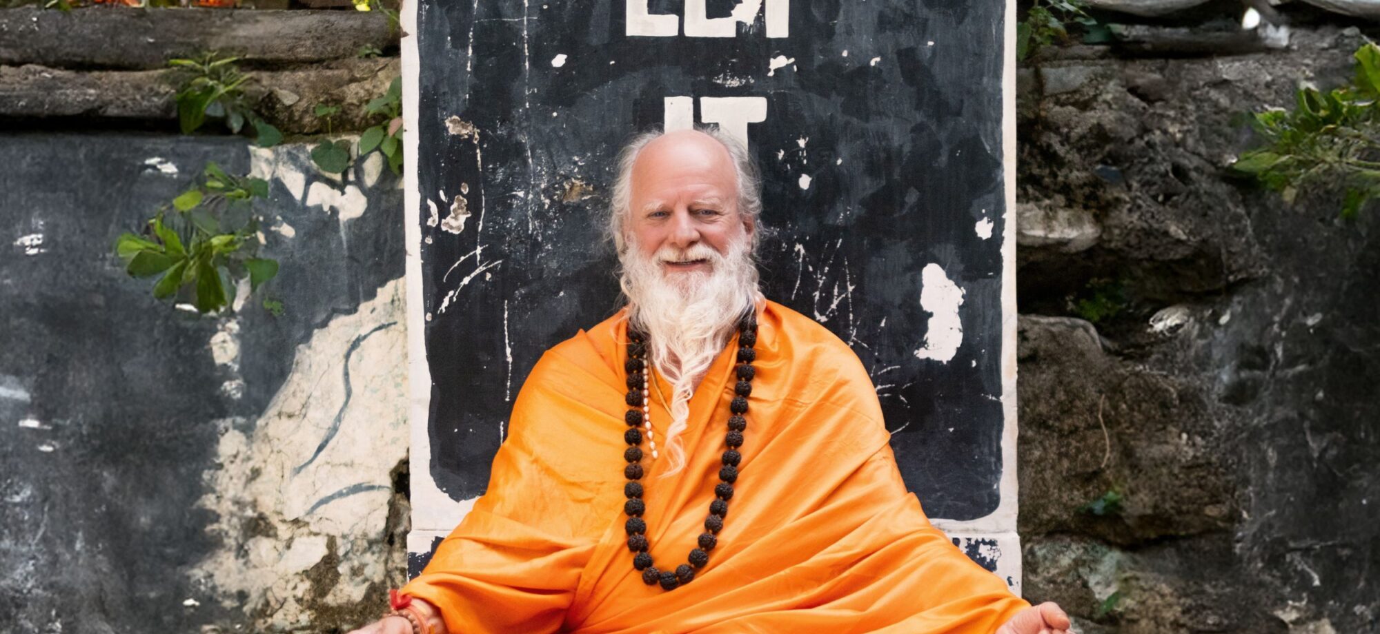 Thom Knoles sitting wearing a yellow robe