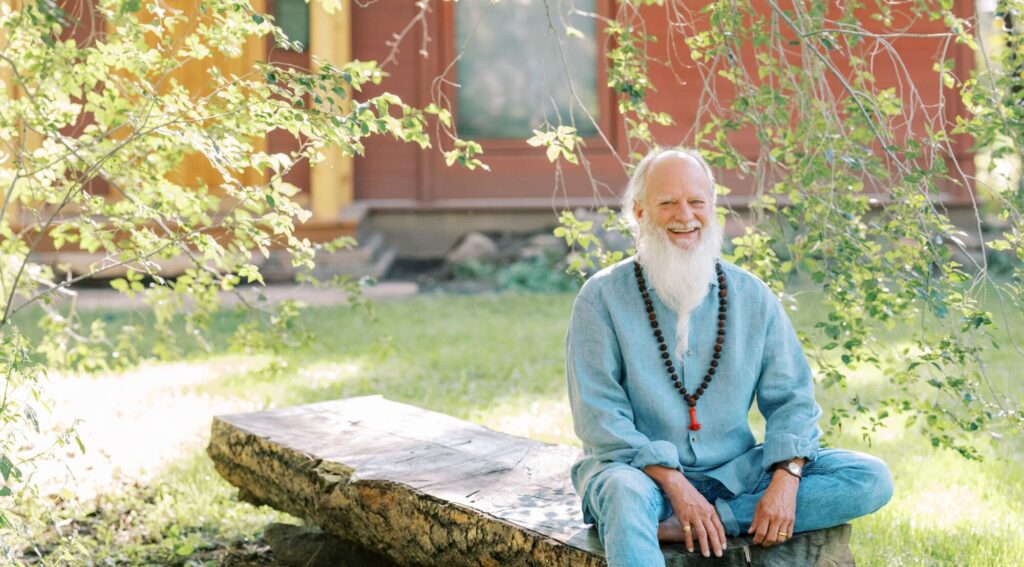 Thom Knoles sitting on a log