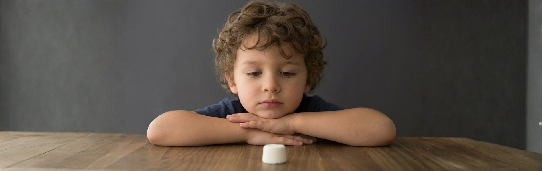 boy tempted to eat a marshmallow
